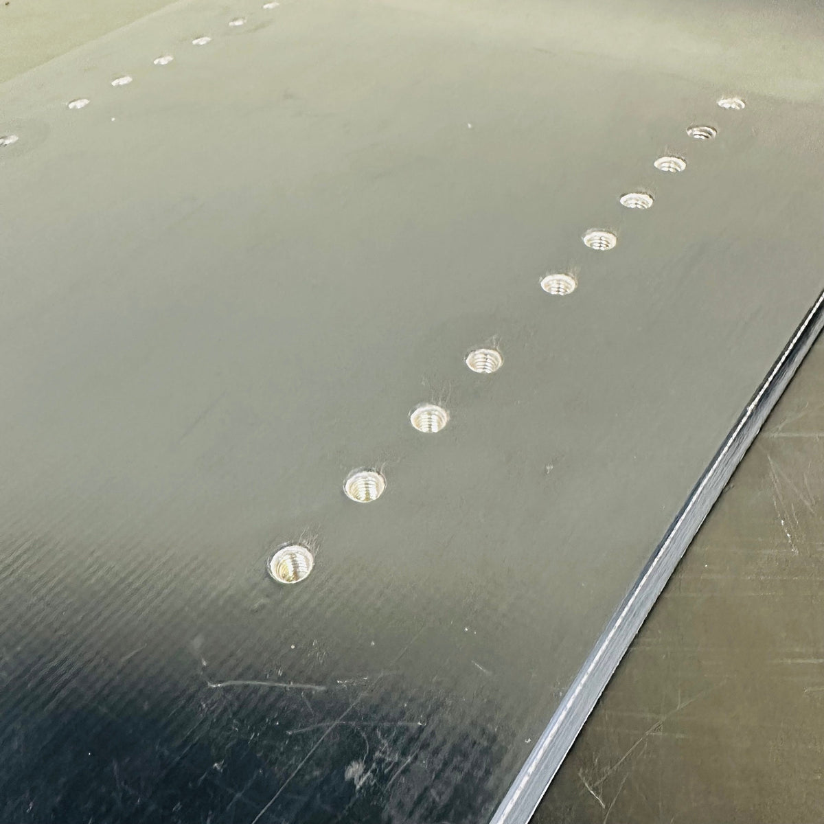 Used TORINITY SSST hard-flex black prototype front board: Close-up of original threaded inserts and topsheet wear