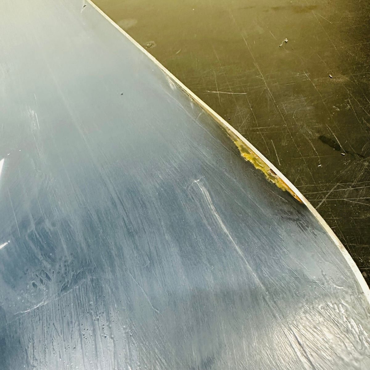 Close-up of base scratches and damage near the edge
